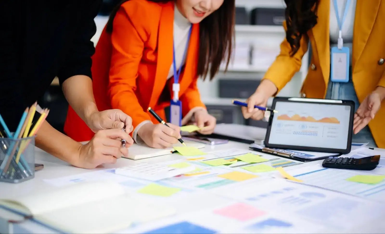 professionals collaborating and reviewing post event roi kpis