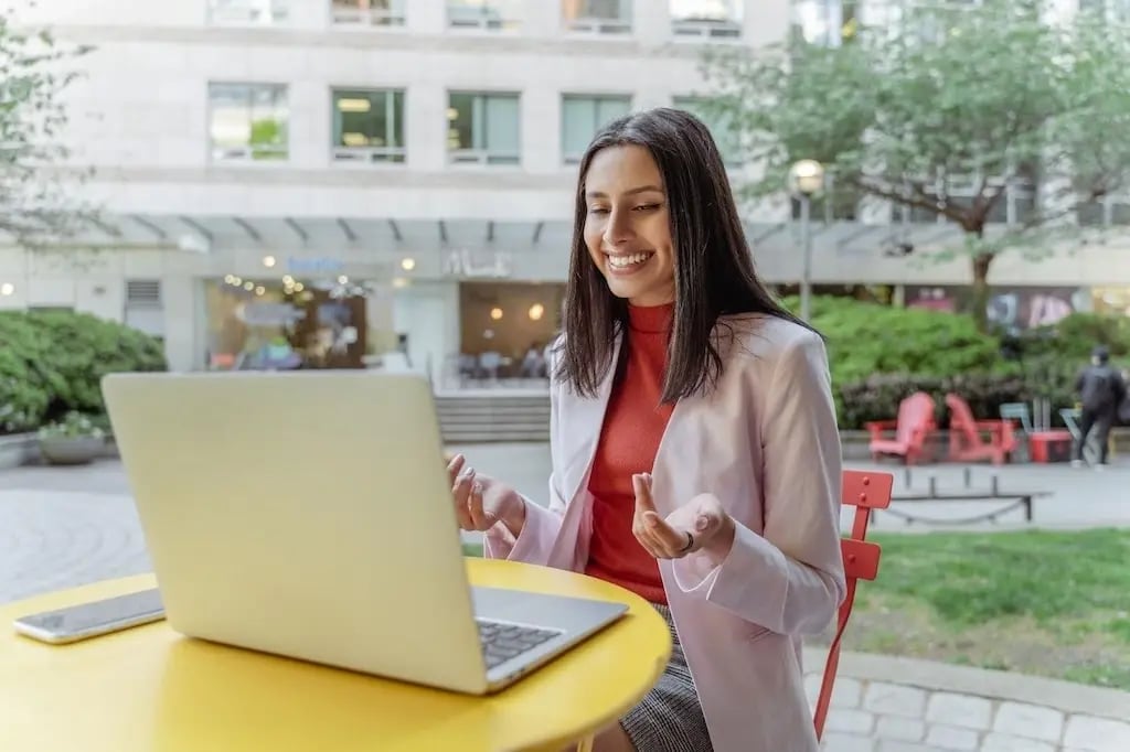 Young Woman Smiling During Video Call Outdoors