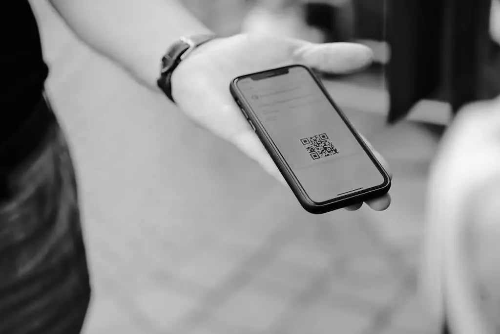 user using QR code with mobile pass to pay