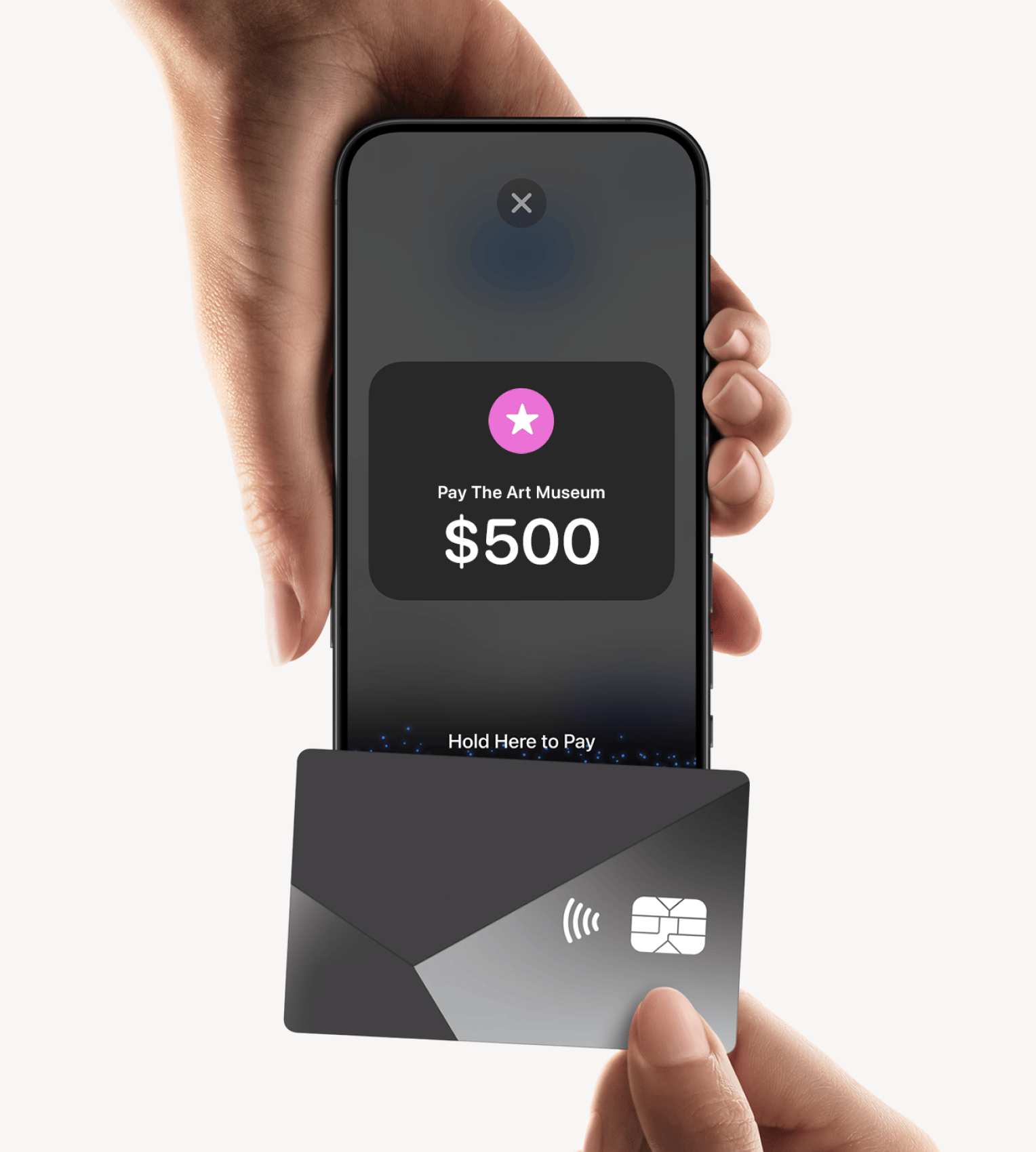 A hand holding a contactless card up to an iPhone displaying a Tap to Pay prompt to pay The Art Museum $500 in zkipster Payments